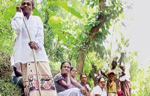 Bereft of public transport,Mr. Pallis and a group of villagers stop to take a rest on their 8-km trek to reach the main road.