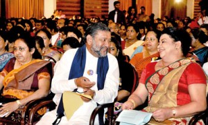 Sharing a light moment: The First Lady with Minister Karaliyadda at the event at Temple Trees.  Pic by Indika Handuwala