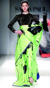 Model walks in a neon green designer saree with black printed work by Satya Paul during the Wills Lifestyle India fashion week (Reuters)