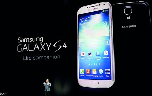 JK Shin, President and head of IT and Mobile Communication Division, introduces Samsung 's Galaxy S4 phone in New York (Reuters)