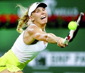 Caroline Wozniacki of Denmark lunges for a shot while playing Angelique Kerber during the BNP Paribas Open at the Indian Wells Tennis Garden on March 15, 2013 in Indian Wells, California.