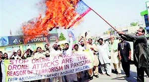 A Pakistani demonstrator carries a burning US flag in a protest in this file photo (AFP)