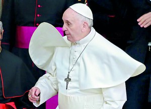 Newly elected Pope Francis, Cardinal Jorge Mario Bergoglio of Argentina's cape blows in wind as he leaves after praying at basilica in Rome