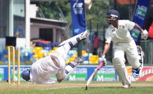 Thurstan batsman Charana Nanayakkara makes it to the crease on time to beat Isipathana wicketkeeper Kavindu Kulasekara who makes an acrobatic attempt for a run out.   - Pic by Amila Gamage