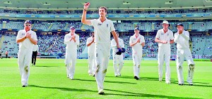 England’s Steven Finn leads England off after equalling his best figures