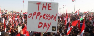 Iraqis wave their national flag and banners during a protest on March 16, 2013, in the city of Kut, south of the capital Baghdad, on the occasion of the tenth anniversary since the US-led invasion of Iraq. Demonstrators also called for the Iraqi government to provide basic services, to release prisoners they say are wrongfully held, and an end to oppression. AFP