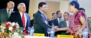 Chief Justice 43 Shirani Bandaranayake congratulates Upul Jayasuriya, the new President of the Bar Association of Sri Lanka, soon after he was inducted at the convocation held at the Navarangahala yesterday. Also at the head table are former Supreme Court judge C.V. Vigneswaran (extreme left) and former Attorney General Sunil de Silva. Pic by Indika Handuwela