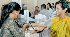 Invitees getting their pressure checked in the foyer of the event venue. Pix by Nilan Maligaspe