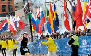 Police and runners react to an explosion during the Boston Marathon finish area in Boston, Massachusetts, April 15.  Two simultaneous explosions ripped through the crowd at the finish line of the Boston Marathon on Monday, killing three  people and injuring dozens on a day when tens of thousands of people packed the streets to watch the world famous race. REUTERS