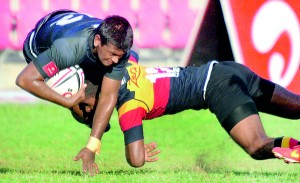 The Number 12s of S. Thomas’ and Trinity collide in their traditional rugby encounter played at Havelock Park in Colombo yesterday. 							- Pic by Amila Gamage