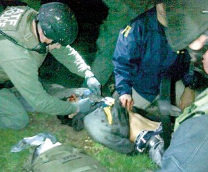 This striking picture show Dzhokhar Tsarnaev lying on the ground of the property of 67 Franklin Street in Watertown after authorities apprehended him. It is not known if the bag visible in the bottom left belongs to the suspect (Daily Mail)