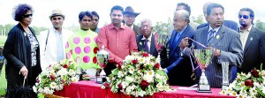 Winning owner of  the Sunquick Cup C.R. Rajapaksa receiving the trophy from chief guest Tommy Ellawala, Chairman C.W. Mackie PLC who were the sponsors of the horse racing meet. 							- Pix by Ranjith Perera
