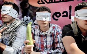 An opposition activist holds a courgette, which represents corruption and nepotism in Egyptian culture, during an anti-government demonstration in Cairo on April 17. AFP