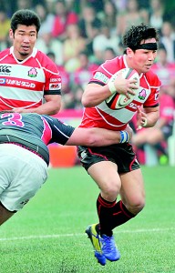 Japan's Kosei Ono (R) is tackled by Hong Kong's James Cooper (L) during the Asian Five Nations rugby tournament in Hong Kong on April 27, 2013. AFP