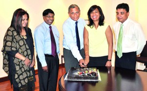 Pic shows - Ms. Neela Marikkar, Chairperson of the Grant Group of Companies and Hemaka Amarasuriya – Chairman of Singer Sri Lanka cutting a cake in celebration of their five decade long partnership. Also present are Ms. Laila Gunesekera, Vice President of the Grant Group,  Asoka Peiris, Group Chief Executive Officer of Singer Sri Lanka and Nasser Majeed, Marketing Director of Singer Sri Lanka.