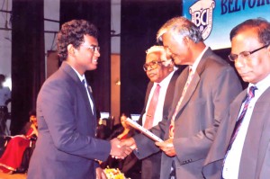 Aniston A Mariyanayagam receiving his Scholarship for the High Achievement at IGCSE 2012 from the Chief Guest Prof.M.Ubayasiri de Silva at the Prize Giving 2013