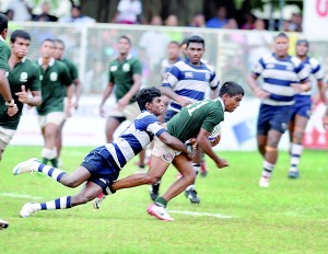 A Josephian defender tries to bring down an Isipathana three-quarter at Longdon Place. 		         - Pic by Ranjith Perera