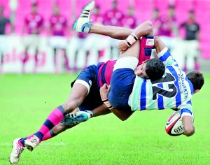 CR&FC ‘A’ player Piyum Jayasinghe brings down an Air Force ‘B’ player in their game - Pic by Amila Gamage