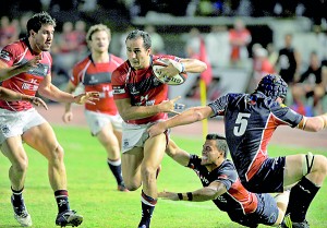 Rugby player Sebastien Alfonsi (C) of Hong Kong is tackled by Philippine rugby player Michael Letts during their Rugby Asian Five-Nations match at the Rizal Memorial stadium in Manila on May 4, 2013. Hong Kong won 59-20. AFP