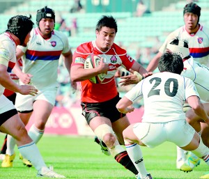 Japan's Yu Tamura (C) carries the ball among South Korea's players during their Asian 5 Nations rugby match in Tokyo on May 4, 2013. Japan beat South Korea 64-5. AFP