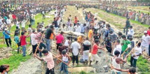 Mass burial: The bodies of 34 unidentified garment workers killed when the Rana Plaza building collapsed in Bangaladesh have been interred in a mass burial a week after the disaster