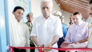 Founder of the Thinakurral newspaper, S.P. Samy cutting the ribbon.  Pix by  T. Premananth