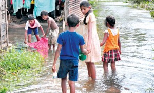 Flooded out: Children in the shanty dwellings on Nuga Road in Wanawasala