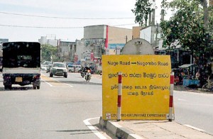 These two boards sit almost at the turn-off itself and cause a build-up of traffic as drivers struggle to make the detour to turn onto the Negombo road