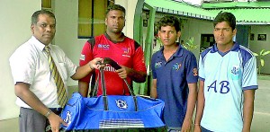SLC’s Kamal Dharmasiri handing over the cricket gear to Sanjeewan (L), Tudor (centre) and Silojan (R).