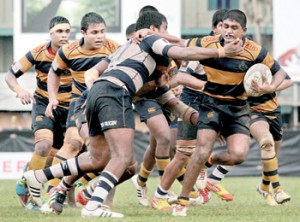 A Royal forward, with the ball, tries to make a break but is held back by a Josephian defender. 		- Pic by Amila Gamage