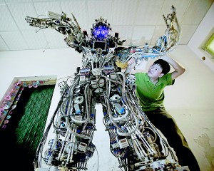 Chinese inventor Tao Xiangli welds a component of his self-made robot (back) at the yard of his house in Beijing, May 15. Tao, 37, spent about 150,000 yuan (USD 24,407 ) and more than 11 months to build the robot out of recycled scrap metals and electric wires that he bought from a second-hand market. The robot is 2.1-metre-tall and around 480 kilograms (529 lbs) in weight, local media reported (Reuters)
