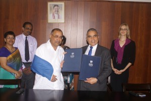 An MoU was signed this week between Singapore’s Lee Kuan Yew School of Public Policy and the Finance Ministry for the training of local public sector officials. Seen here is Treasury Secretary Dr P.B. Jayasundera, wearing a shoulder strap due to a dislocated elbow, and Prof. Kishore Mahbubani Dean of the LKY School of Public Policy, National University of Singapore along with senior Ministry officials. (Picture courtesy Finance Ministry)