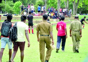 Incidents like this happen elsewhere other than in the rugby grounds: Two policemen are seen escorting out two players and a team official after they were accused of verbally abusing a match official at the 46th Junior National Hockey tournament yesterday. - Pic by Amila Gamage.