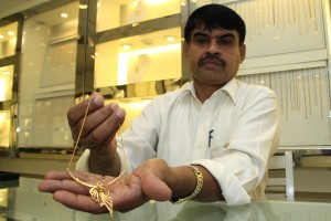 A salesman at a local store displays a necklace. Pic. by Indika Handuwala