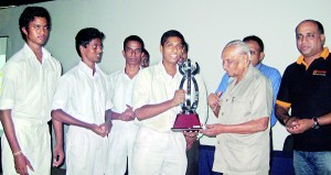 Pictured here is the captain of Ananda College’s team receiving the trophy from Edwin Ariyadasa.