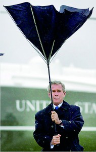 Umbrella issues: Obama is not the first US president to have problems in a bid to stay dry. George W. Bush "battles" with his umbrella after stepping off Marine One at Andrews Air Force Base in 2004 (AFP)
