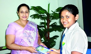 Presenting the book to the Principal Mrs. Sandamali Aviruppola of Vishaka Vidyalaya