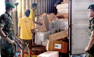 In view of threats from smugglers, Customs officers had to seek help from the Police Special Task Force (STF) yesterday to check a container containing illegally imported items. Pic by M. A. Pushpakumara