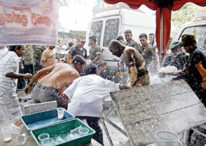 Army personeel and others help to douse the fire. Pic courtesy Lankadeepa