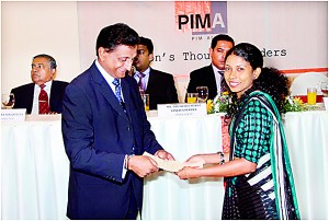 Ms. N.S. Dharmadasa from Wijeya News Papers receiving her certificate from the PIMA President Mr. S.G.G. Rajkumar.