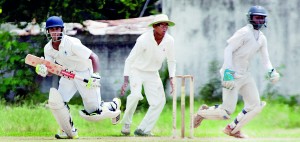 Nimesha Munasinghe of St. Anthony’s desperately tries to make a run duirng his side’s meagre first innings reply of 99 against Wesley’s 175 at Campbell Park. 		 - Pic by Amila Gamage