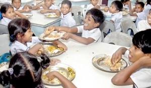 Caring and sharing: Children enjoying a nutritious lunch at Samata Sarana. Pix by Nilan Maligaspe