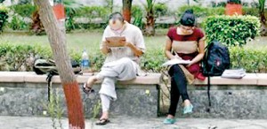 Indian students study inside the Delhi University campus in New Delhi (REUTERS)