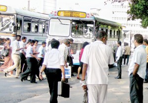 Passengers rush to enter a bus which had stopped at a pedestrian crossing