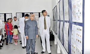 Royal Principal Upali Gunasekara and Mr. Weeraman looking at the exhibits