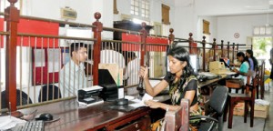 Staff at the counters attending to the public. Pix by Indika Handuwala