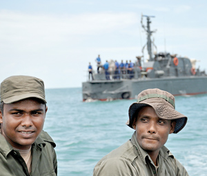 The two Special Boat Squadran men who steered the flat bottom fibre glass boat that took the Sunday Times team to Kachchativu seen in the foreground, while the Dvora that brought the team to mid sea is seen in the background