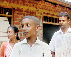 The boy with his parents. Pic by Kanchana Kumara Ariyadasa
