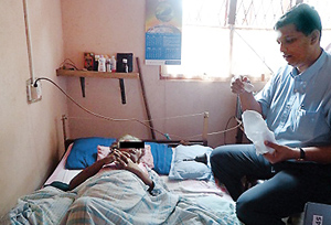 Home visit:Dr. Rajapaksa by a patient’s bedside
