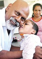 Ganesh Velautham with a young patient. Pix by Nilan Maligaspe